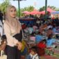 Winda bersama rekannya tampak antusias mendampingi buah hati mereka yang sedang serius mengikuti lomba mewarnai di Lapangan Sanggar Pramuka, Gelora November Pertamina, Pendopo, pada Minggu, 21/6/2026. (Foto: Dok/tintamerah.co)  